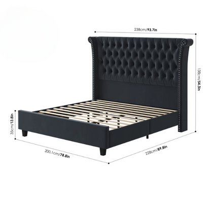 Dark grey velvet king-size platform bed with tall tufted wingback headboard, nailhead trim, and no box spring required

