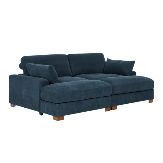 Deep blue corduroy convertible sleeper sofa with adjustable headrest, twin bed functionality, and mid-century wood legs