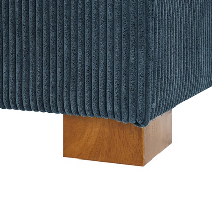 Deep blue corduroy convertible sleeper sofa with adjustable headrest, twin bed functionality, and mid-century wood legs