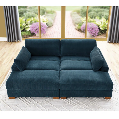 Deep blue corduroy convertible sleeper sofa with adjustable headrest, twin bed functionality, and mid-century wood legs