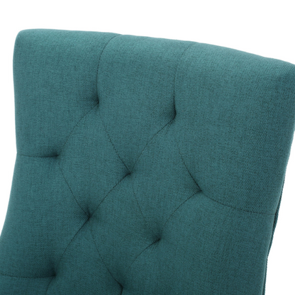 Set of four deep teal upholstered dining chairs with diamond tufted backs, armless design, sloped sides, and espresso brown wooden legs.

