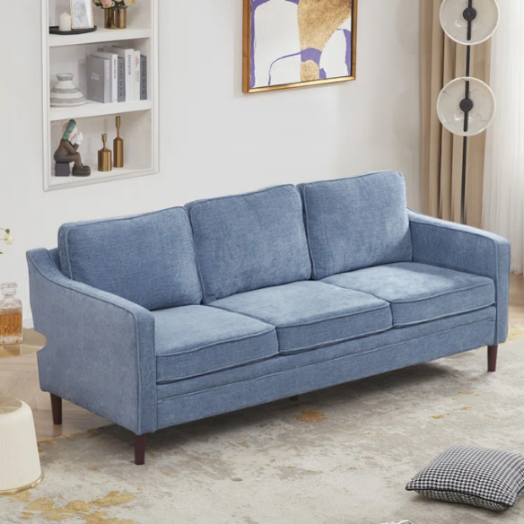 Dusty blue chenille upholstered sofa featuring curved track arms, tapered wooden legs, and foam-filled cushions in a mid-century modern design.