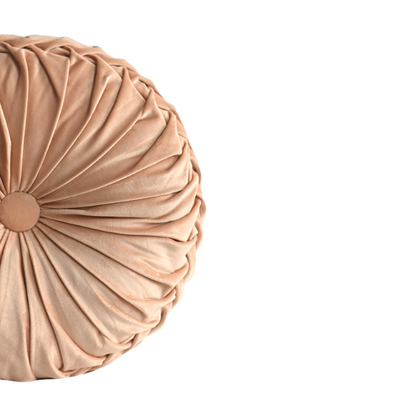 Dusty rose velvet round throw pillows with pleated detail and central button, set of two 14.5-inch decorative cushions styled on a soft-toned couch.


