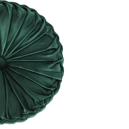 Emerald green velvet round throw pillows with hand-pleated detail and central button, 14.5-inch set of two on a white sofa in a stylish living room.


