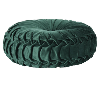 Emerald green velvet round throw pillows with hand-pleated detail and central button, 14.5-inch set of two on a white sofa in a stylish living room.

