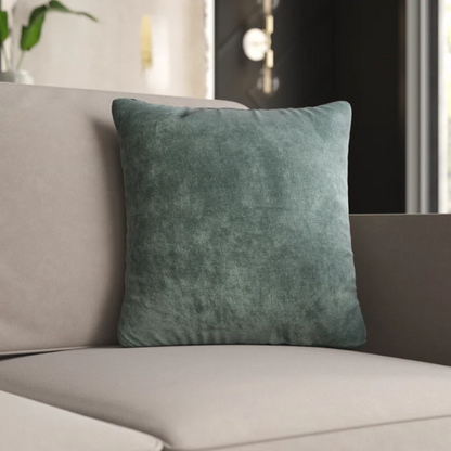 Forest green crushed velvet throw pillow, 16x16 square design with soft texture and reversible fabric, styled on a modern sofa for cozy, nature-inspired home decor.

