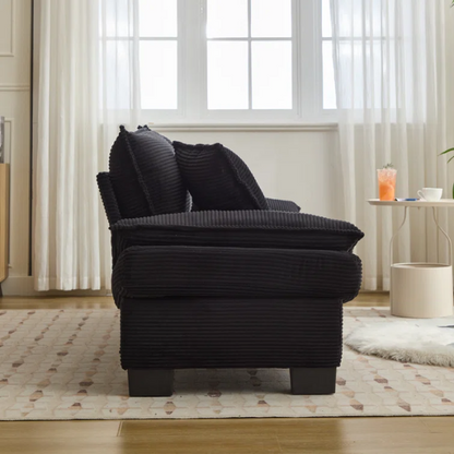 84-inch black corduroy loveseat with striped upholstery, pillow-top arms, and two accent pillows—modern, low-profile design ideal for contemporary living rooms or compact spaces.

