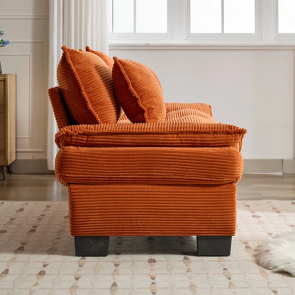84-inch burnt orange corduroy loveseat with striped upholstery, pillow-top arms, and two accent pillows—modern, low-profile design ideal for vibrant, stylish interiors.

