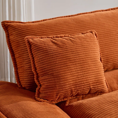 84-inch burnt orange corduroy loveseat with striped upholstery, pillow-top arms, and two accent pillows—modern, low-profile design ideal for vibrant, stylish interiors.

