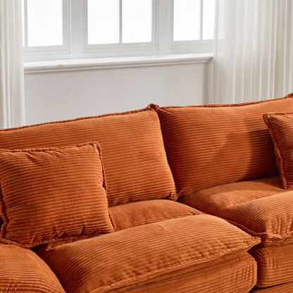 84-inch burnt orange corduroy loveseat with striped upholstery, pillow-top arms, and two accent pillows—modern, low-profile design ideal for vibrant, stylish interiors.

