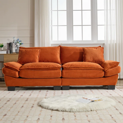 84-inch burnt orange corduroy loveseat with striped upholstery, pillow-top arms, and two accent pillows—modern, low-profile design ideal for vibrant, stylish interiors.

