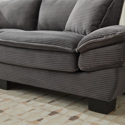 84-inch grey corduroy loveseat with striped upholstery, pillow-top arms, and two accent pillows—modern, low-profile design ideal for living rooms, apartments, or home offices.

