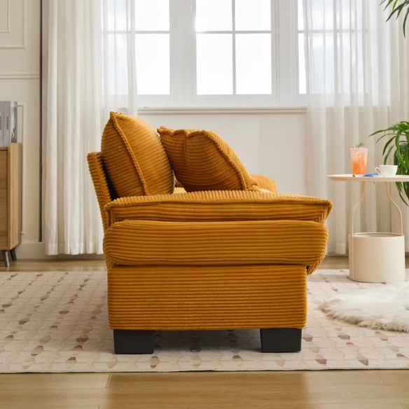 84-inch mustard yellow corduroy loveseat with striped upholstery, pillow-top arms, and two accent pillows—modern, low-profile design ideal for stylish living rooms, apartments, or creative spaces.

