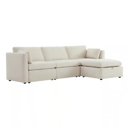 Beige modular four-piece sectional sofa with wide seats, soft chenille fabric, removable cushions, and built-in storage ottoman — ideal for modern and adaptable living room layouts.

