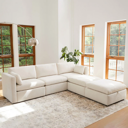 Beige five-piece modular sectional sofa with wide chenille-upholstered seats, two gas-lift storage ottomans, and reversible cushions — a modern and comfortable centerpiece for any living room.

