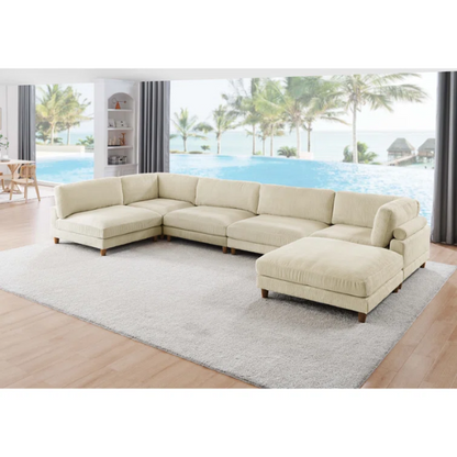 Beige modular sectional sofa with corduroy upholstery, removable cushions, and matching ottoman – seats six in a modern L-shaped or U-shaped layout with solid wood legs.

