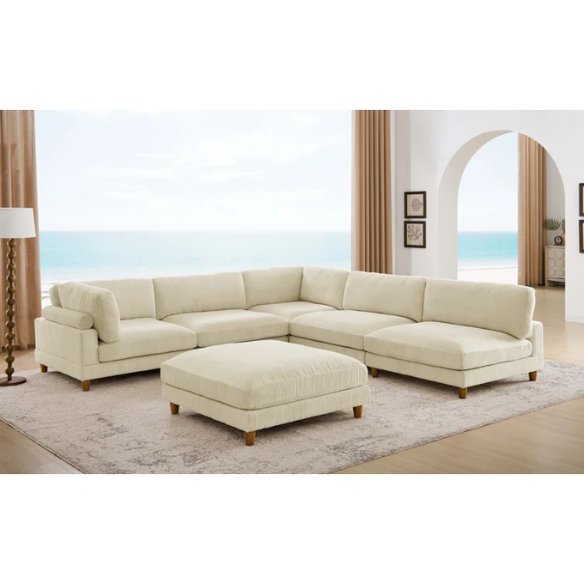 Beige modular sectional sofa with corduroy upholstery, removable cushions, and matching ottoman – seats six in a modern L-shaped or U-shaped layout with solid wood legs.

