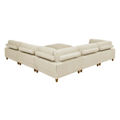 Beige modular sectional sofa with corduroy upholstery, removable cushions, and matching ottoman – seats six in a modern L-shaped or U-shaped layout with solid wood legs.

