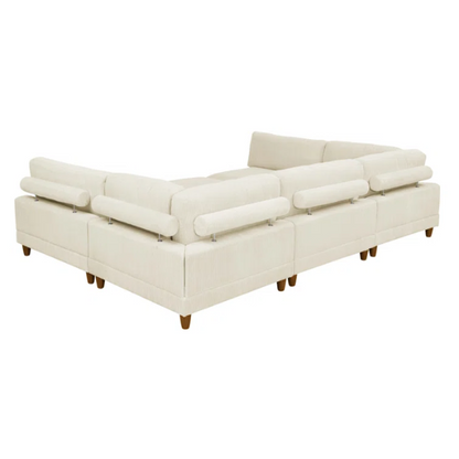 Beige modular sectional sofa with corduroy upholstery, removable cushions, and matching ottoman – seats six in a modern L-shaped or U-shaped layout with solid wood legs.


