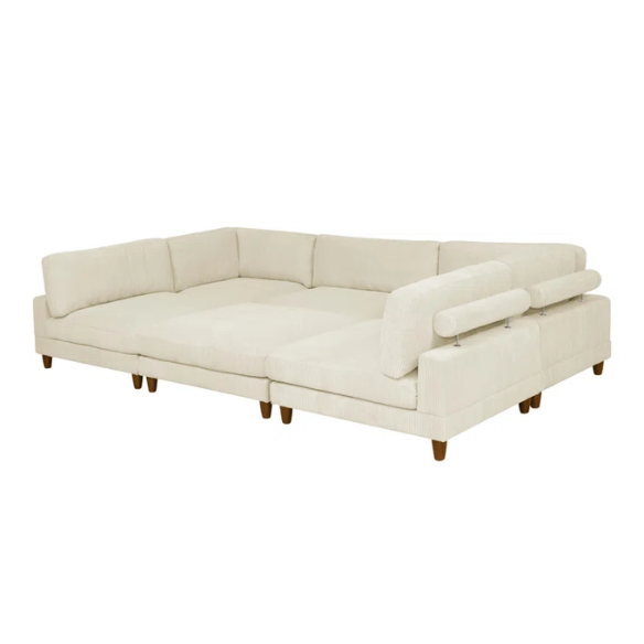 Beige modular sectional sofa with corduroy upholstery, removable cushions, and matching ottoman – seats six in a modern L-shaped or U-shaped layout with solid wood legs.

