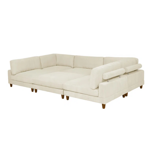 Beige modular sectional sofa with corduroy upholstery, removable cushions, and matching ottoman – seats six in a modern L-shaped or U-shaped layout with solid wood legs.

