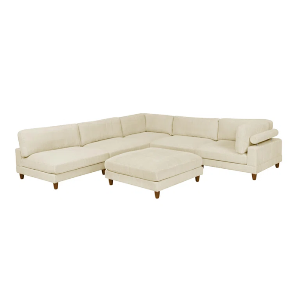 Beige modular sectional sofa with corduroy upholstery, removable cushions, and matching ottoman – seats six in a modern L-shaped or U-shaped layout with solid wood legs.

