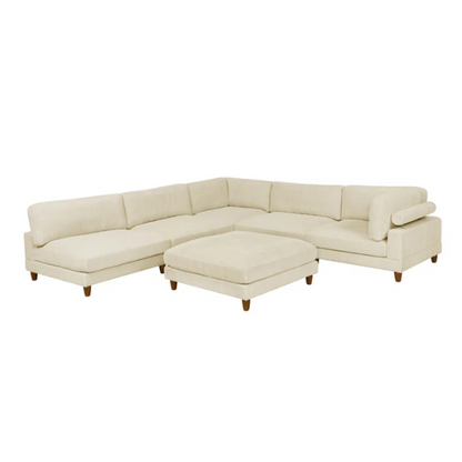 Beige modular sectional sofa with corduroy upholstery, removable cushions, and matching ottoman – seats six in a modern L-shaped or U-shaped layout with solid wood legs.

