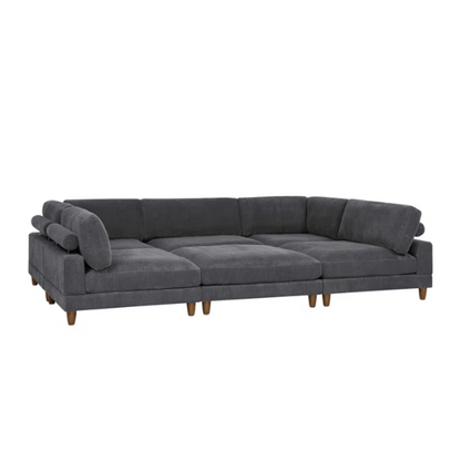 Dark grey modular sectional sofa with soft corduroy upholstery, matching ottoman, and removable cushions — seats six with flexible L- or U-shaped configurations.

