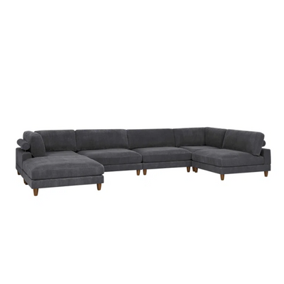 Dark grey modular sectional sofa with soft corduroy upholstery, matching ottoman, and removable cushions — seats six with flexible L- or U-shaped configurations.

