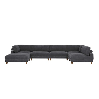Dark grey modular sectional sofa with soft corduroy upholstery, matching ottoman, and removable cushions — seats six with flexible L- or U-shaped configurations.

