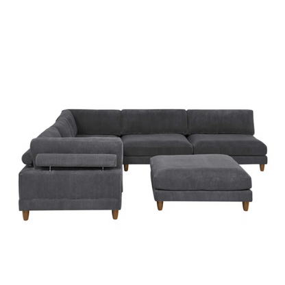 Dark grey modular sectional sofa with soft corduroy upholstery, matching ottoman, and removable cushions — seats six with flexible L- or U-shaped configurations.

