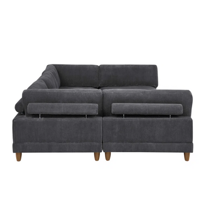 Dark grey modular sectional sofa with soft corduroy upholstery, matching ottoman, and removable cushions — seats six with flexible L- or U-shaped configurations.

