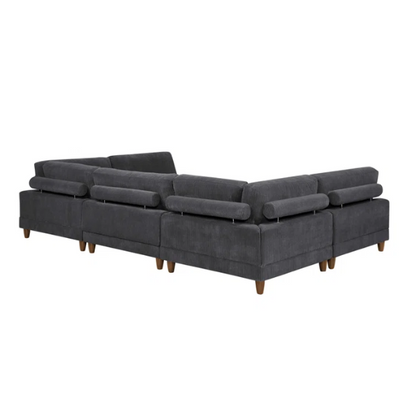 Dark grey modular sectional sofa with soft corduroy upholstery, matching ottoman, and removable cushions — seats six with flexible L- or U-shaped configurations.

