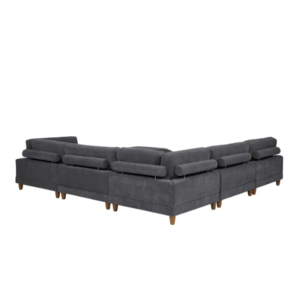 Dark grey modular sectional sofa with soft corduroy upholstery, matching ottoman, and removable cushions — seats six with flexible L- or U-shaped configurations.

