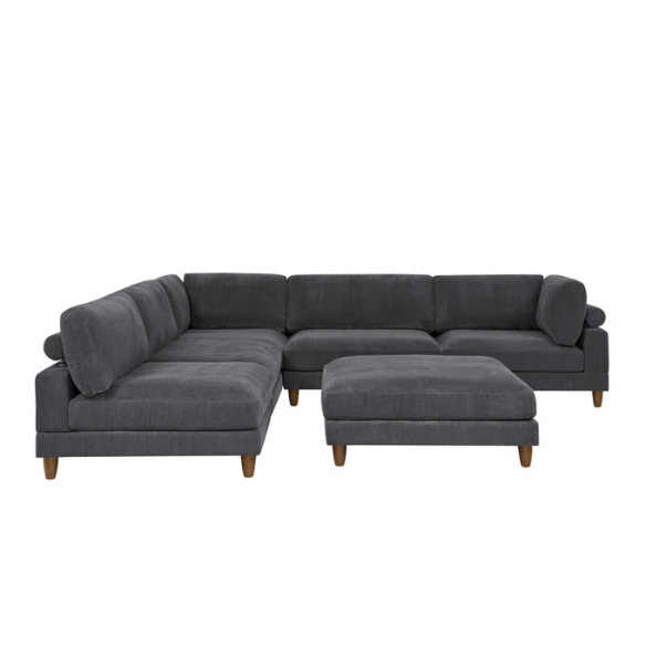 Dark grey modular sectional sofa with soft corduroy upholstery, matching ottoman, and removable cushions — seats six with flexible L- or U-shaped configurations.

