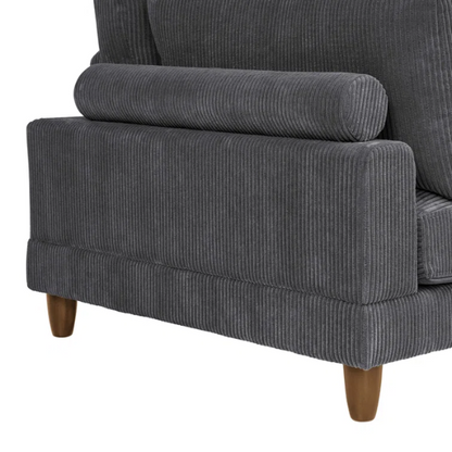Dark grey modular sectional sofa with soft corduroy upholstery, matching ottoman, and removable cushions — seats six with flexible L- or U-shaped configurations.

