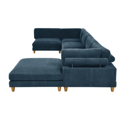 Deep teal modular sectional sofa with plush corduroy fabric, removable cushions, and a matching ottoman — seats six in flexible L- or U-shaped configurations.

