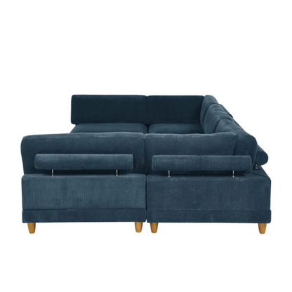 Deep teal modular sectional sofa with plush corduroy fabric, removable cushions, and a matching ottoman — seats six in flexible L- or U-shaped configurations.

