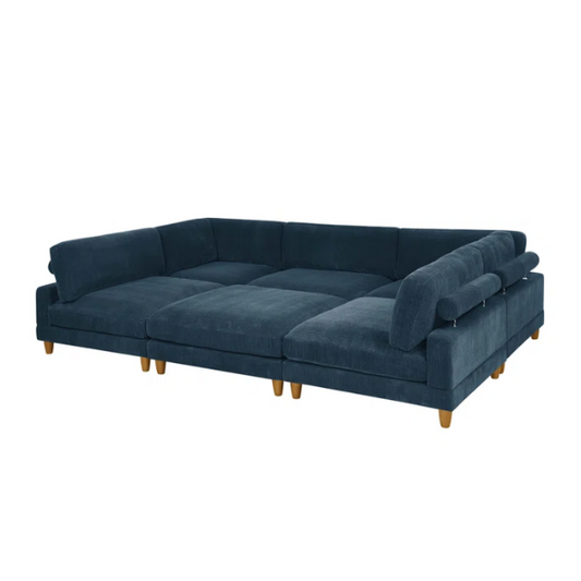 Deep teal modular sectional sofa with plush corduroy fabric, removable cushions, and a matching ottoman — seats six in flexible L- or U-shaped configurations.

