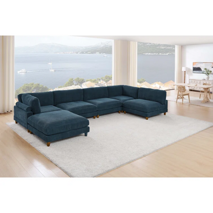 Deep teal modular sectional sofa with plush corduroy fabric, removable cushions, and a matching ottoman — seats six in flexible L- or U-shaped configurations.

