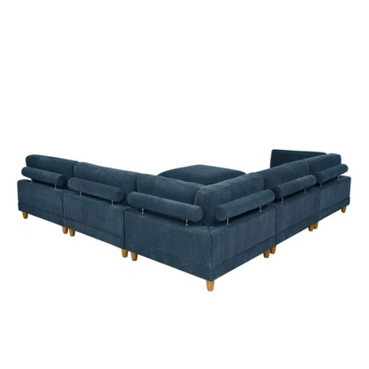 Deep teal modular sectional sofa with plush corduroy fabric, removable cushions, and a matching ottoman — seats six in flexible L- or U-shaped configurations.

