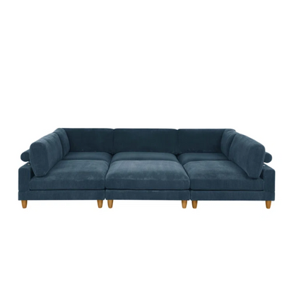 Deep teal modular sectional sofa with plush corduroy fabric, removable cushions, and a matching ottoman — seats six in flexible L- or U-shaped configurations.


