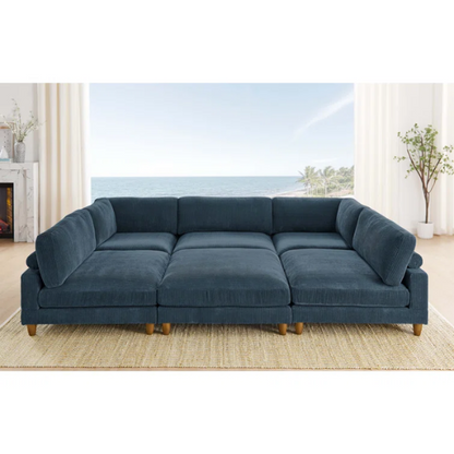Deep teal modular sectional sofa with plush corduroy fabric, removable cushions, and a matching ottoman — seats six in flexible L- or U-shaped configurations.

