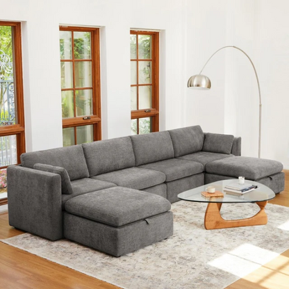 Grey six-piece modular sofa set with wide chenille-upholstered seats, two gas-lift storage ottomans, and plush reversible cushions — perfect for modern or transitional interiors.


