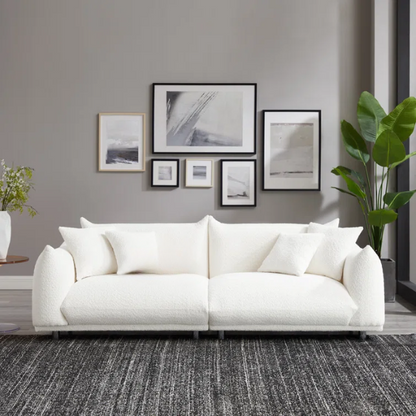 88.9-inch cream white upholstered sofa with chrome legs, deep seating, rounded arms, and four matching accent pillows, ideal for modern or minimalist interiors.


