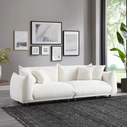 88.9-inch cream white upholstered sofa with chrome legs, deep seating, rounded arms, and four matching accent pillows, ideal for modern or minimalist interiors.

