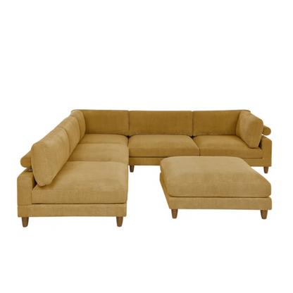 Modular mustard yellow corduroy sectional sofa with removable cushions, deep seating, and a matching ottoman — ideal for bold, spacious living room layouts.


