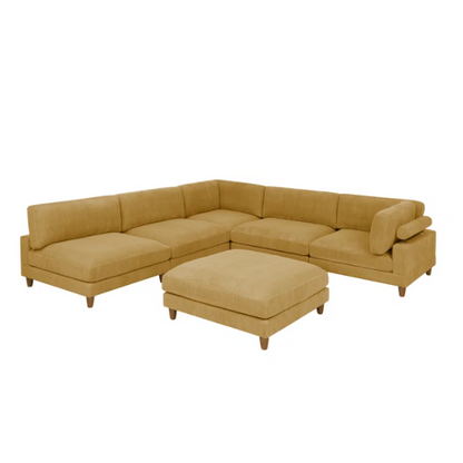Modular mustard yellow corduroy sectional sofa with removable cushions, deep seating, and a matching ottoman — ideal for bold, spacious living room layouts.

