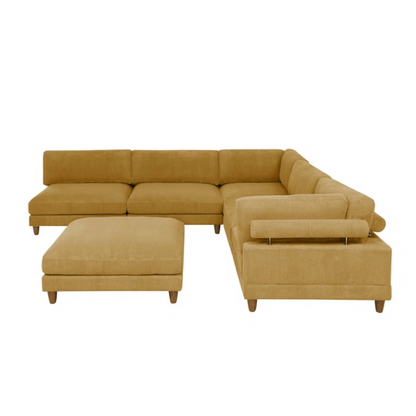 Modular mustard yellow corduroy sectional sofa with removable cushions, deep seating, and a matching ottoman — ideal for bold, spacious living room layouts.

