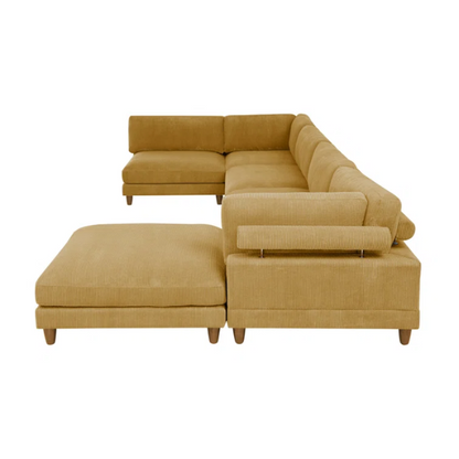 Modular mustard yellow corduroy sectional sofa with removable cushions, deep seating, and a matching ottoman — ideal for bold, spacious living room layouts.

